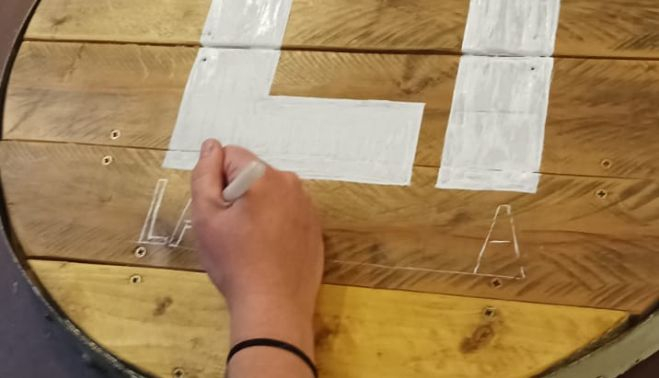 Néstor decora las nuevas mesas con el logo de La Librería