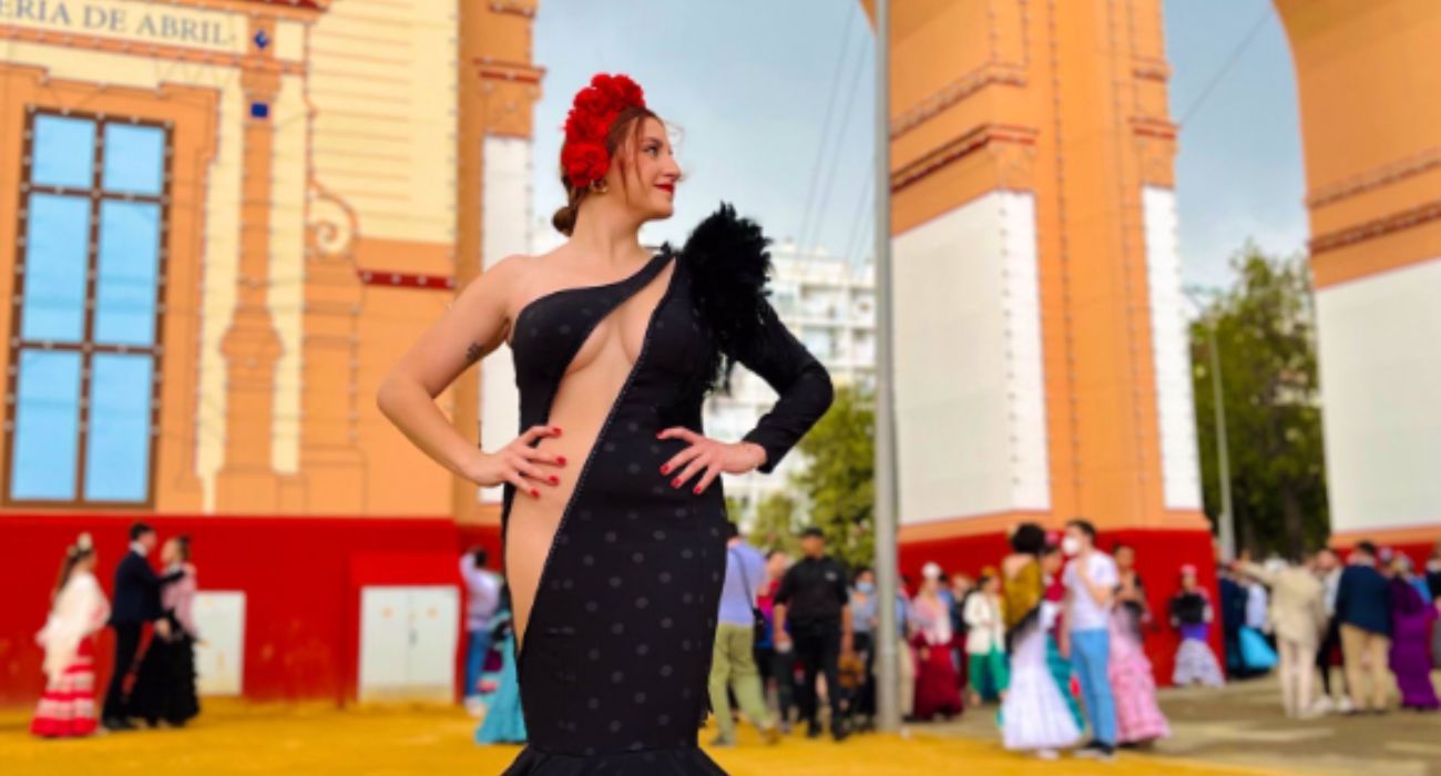La joven, posando con su traje de flamenca, delante de la portada de la Feria de Abril. La joven, posando con su traje de flamenca, delante de la portada de la Feria de Abril.