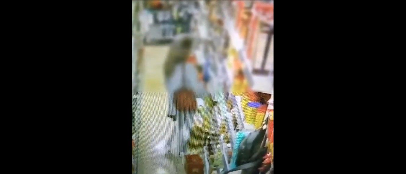 Un momento de la grabación de la cámara de seguridad, donde se ve a la mujer guardarse el aceite en Jerez.