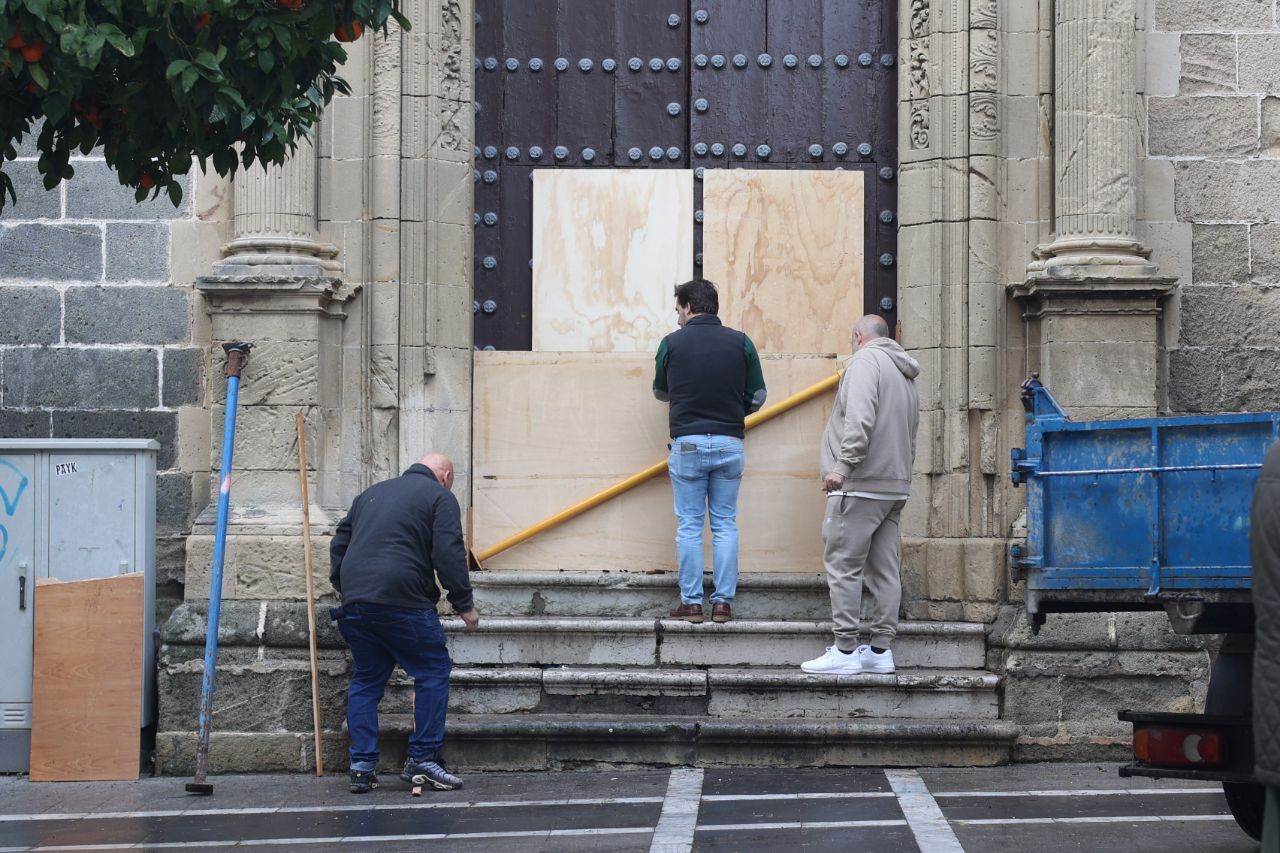 Operarios municipales, tapando la puerta tras el incendio en la iglesia de San Miguel de Jerez.