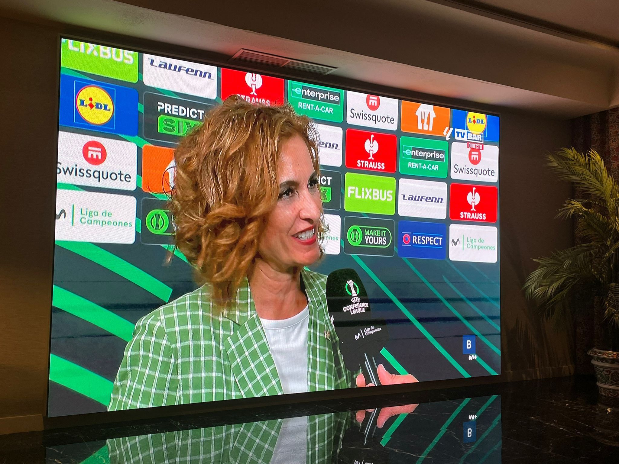 María Jesús Montero, seguidora del Betis, atendiendo a TVE hace unos días en el descanso de la Conference League.
