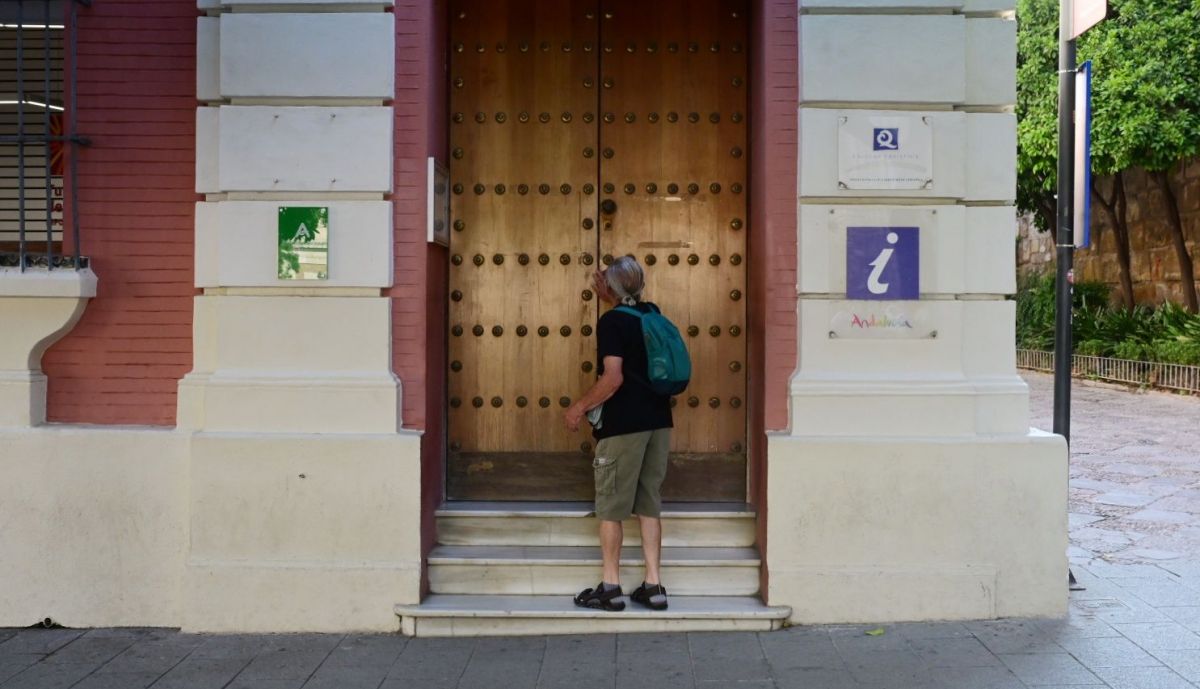 Un turista encuentra la oficina de turismo cerrada.