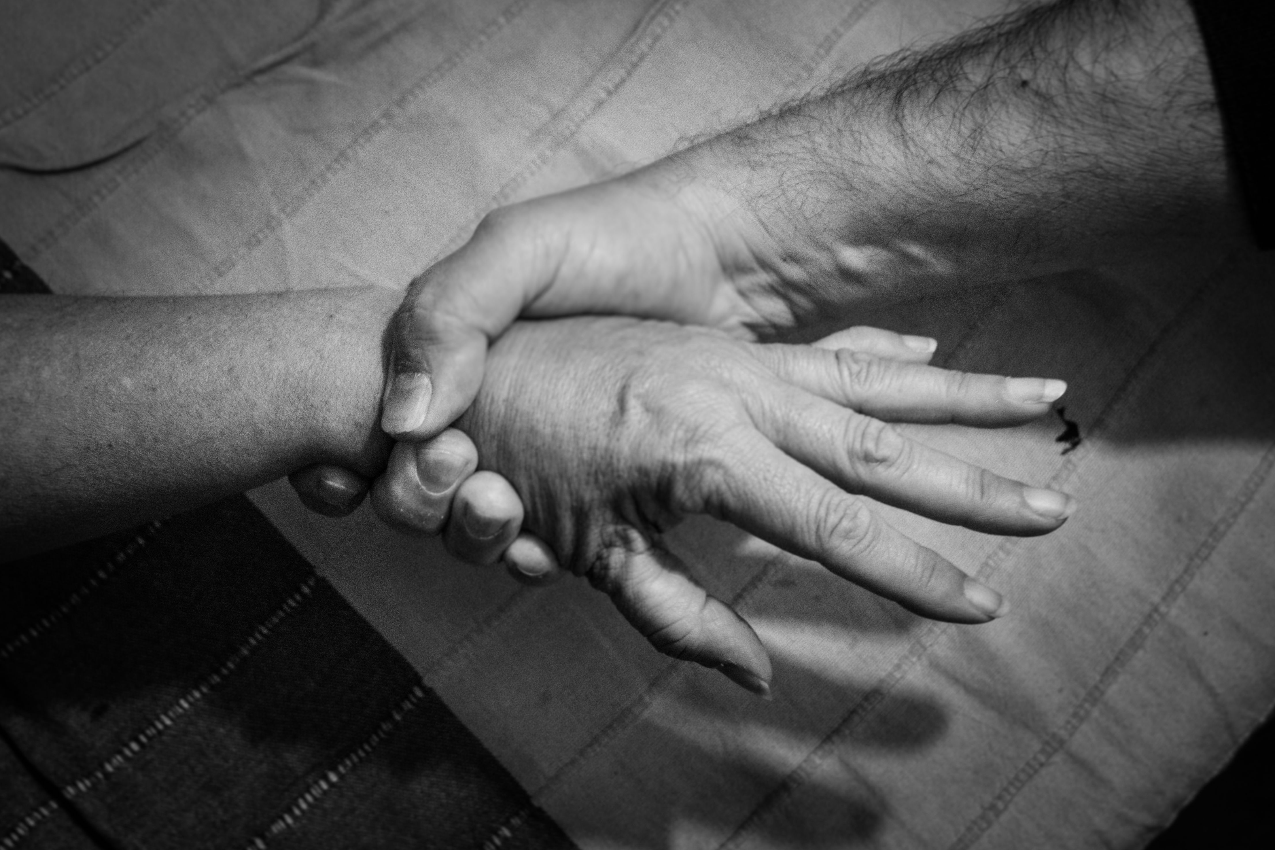 Un hombre agarra con fuerza la mano de una mujer.