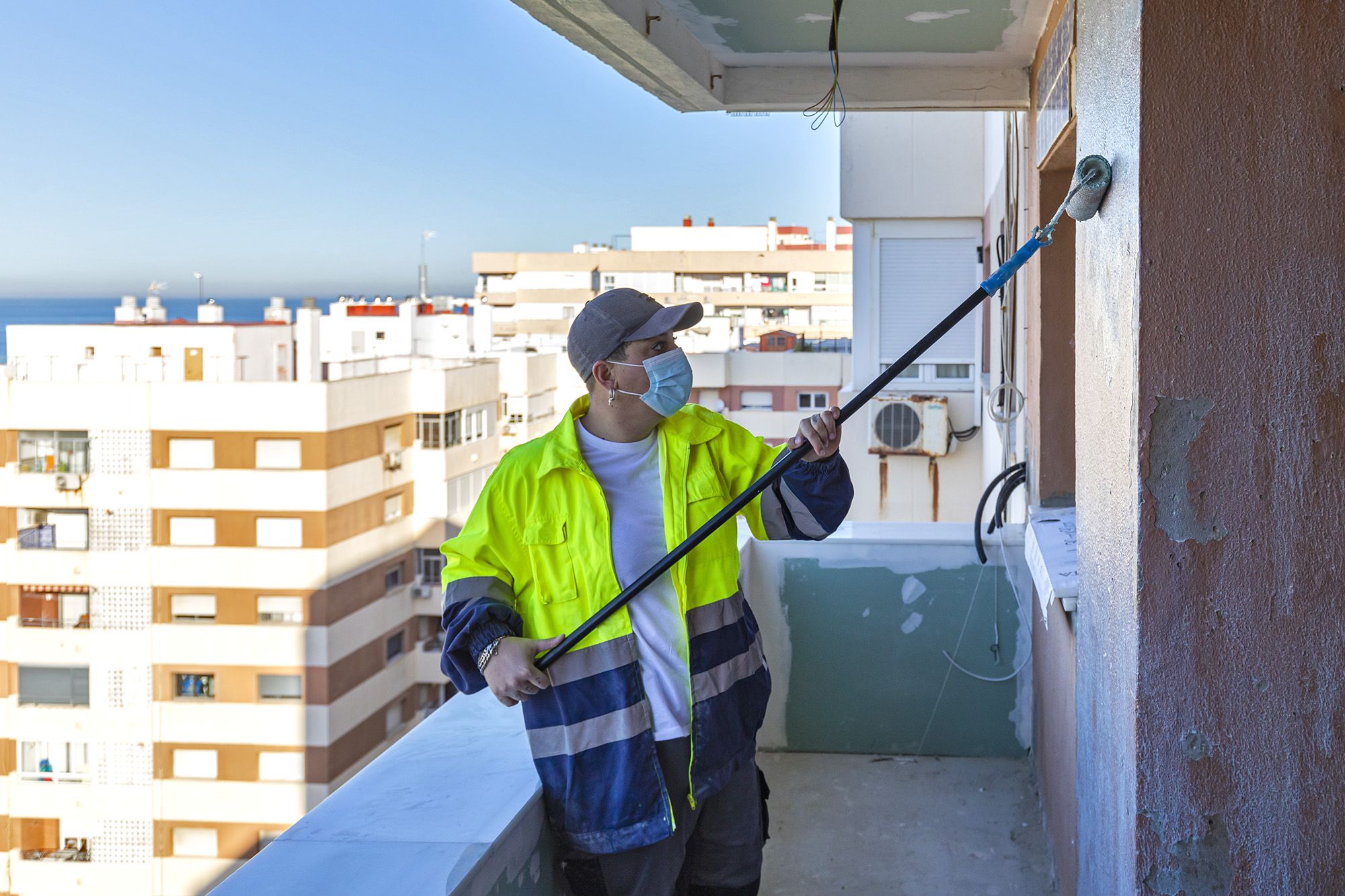 Rosa dando perlita a la pared del piso de Cádiz.
